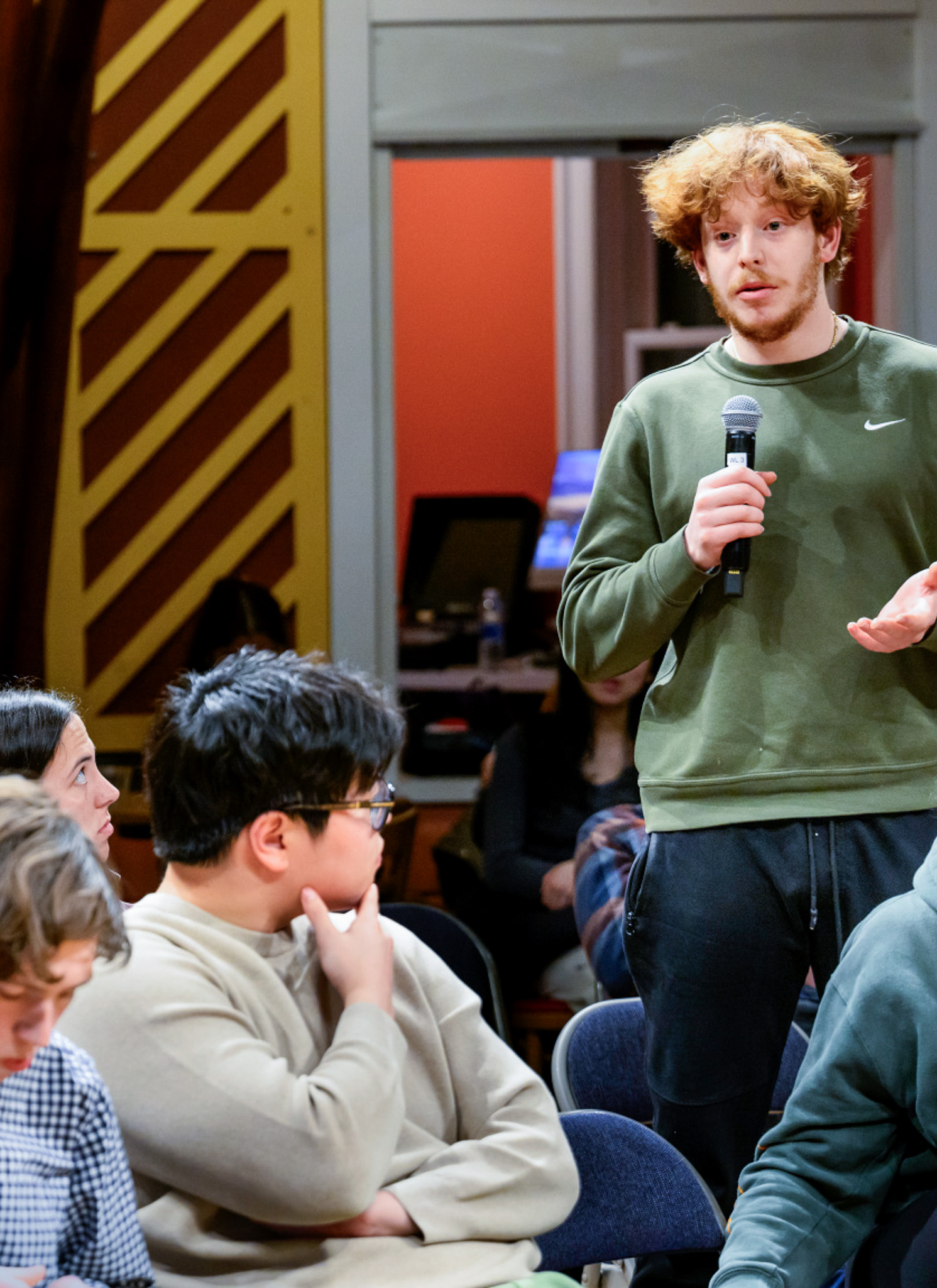 Student speaking with microphone during dialogue event